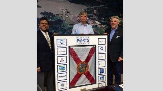 Port Everglades joins the Panama Canal Expansion Celebration in June with Chief Executive Steve Cernak (middle), joined by Port Tampa Bay CEO Paul Anderson (right), presenting a plaque on behalf of the Florida Port's Council for a presentation to Oscar E. Bazán V., Executive Vice President, Planning and Business Development, Panama Canal Authority (left).