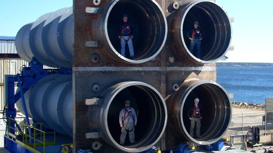 Workers pose with a quad pack of nuclear ballistic missile tubes for the Columbia-class (GDEB)