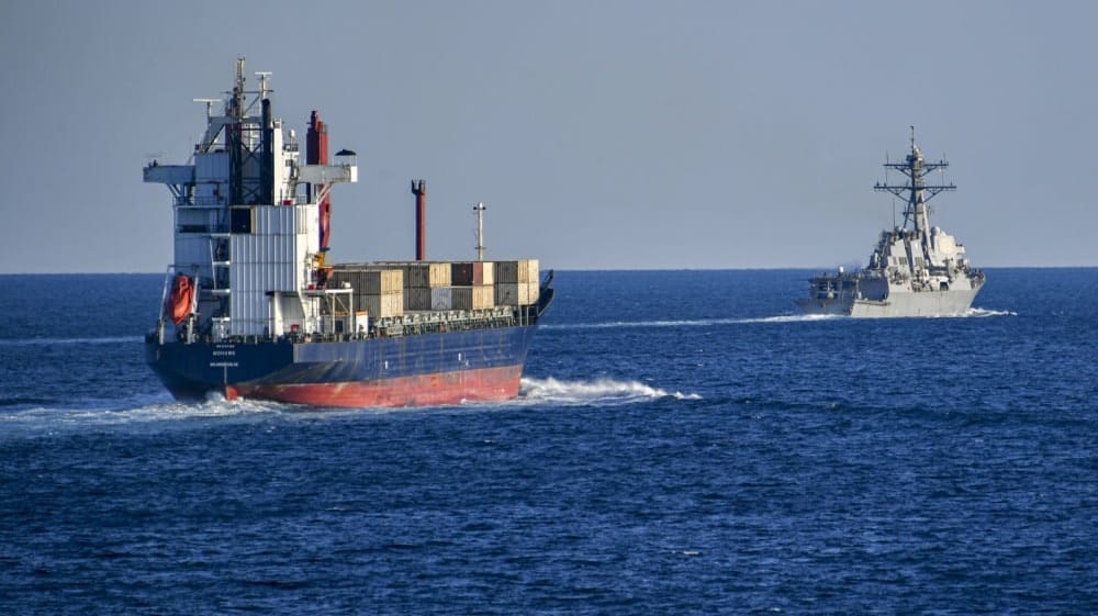 US warship monitoring cargo ship in the Strait of Hormuz
