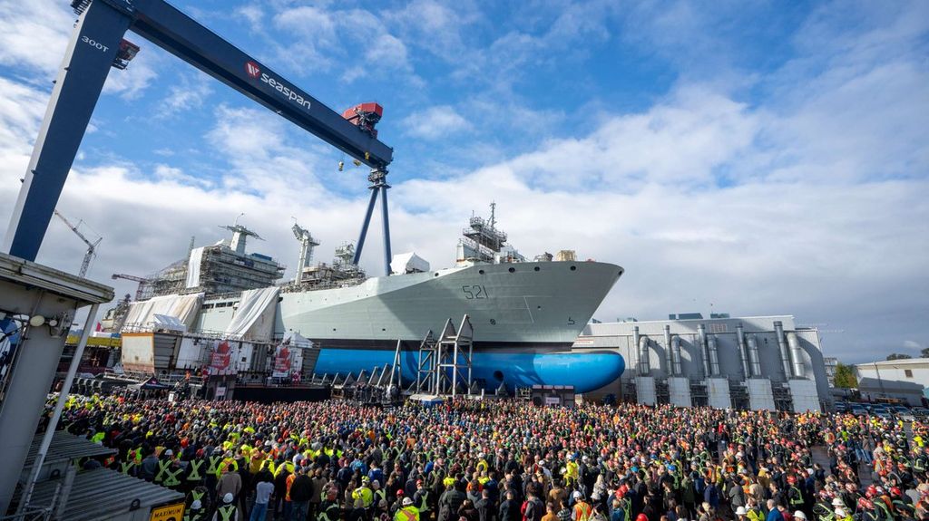 Hundreds of shipyard workers gather for the keel-laying for the future CCGS Imnaryuaq, with a nearly-completed naval auxiliary in the background (CCG)