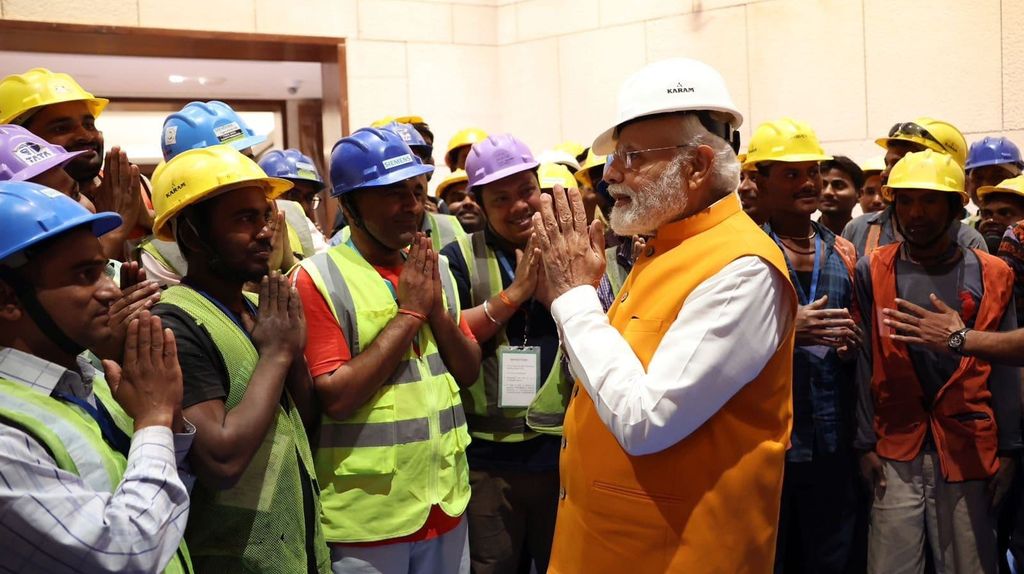 Prime Minister Modi in a hard hat mixes in amongst Indian construction workers (KARAM)