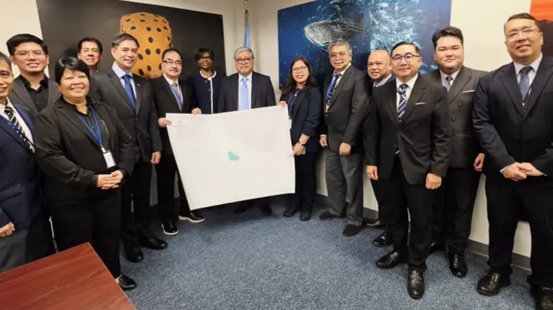 The Philippine delegation presenting the official copy of NAMRIA Chart No. 1567 entitled “Bajo de Masinloc and Approach” with DOALOS Deputy Director Alice Hicuburundi, centre left (DFA Philippines)