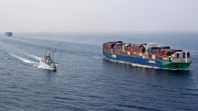 warship escorting containership in the Red Sea
