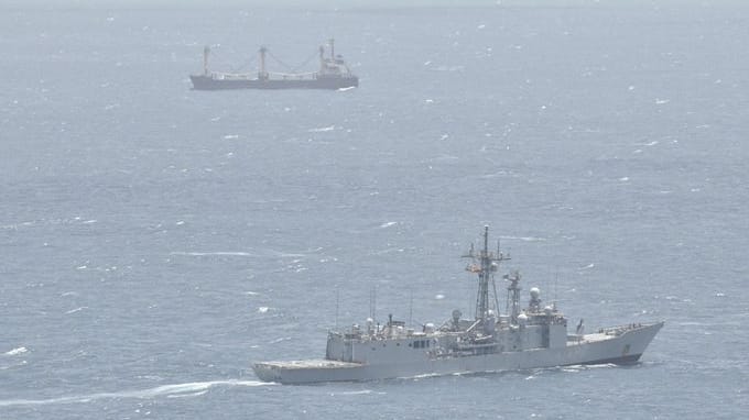 warship monitoring hijacked cargo ship