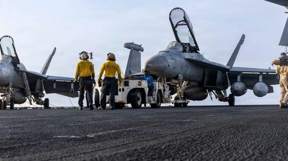 Sailors at work on the flight deck of USS Abraham Lincoln, July 30 (USN)