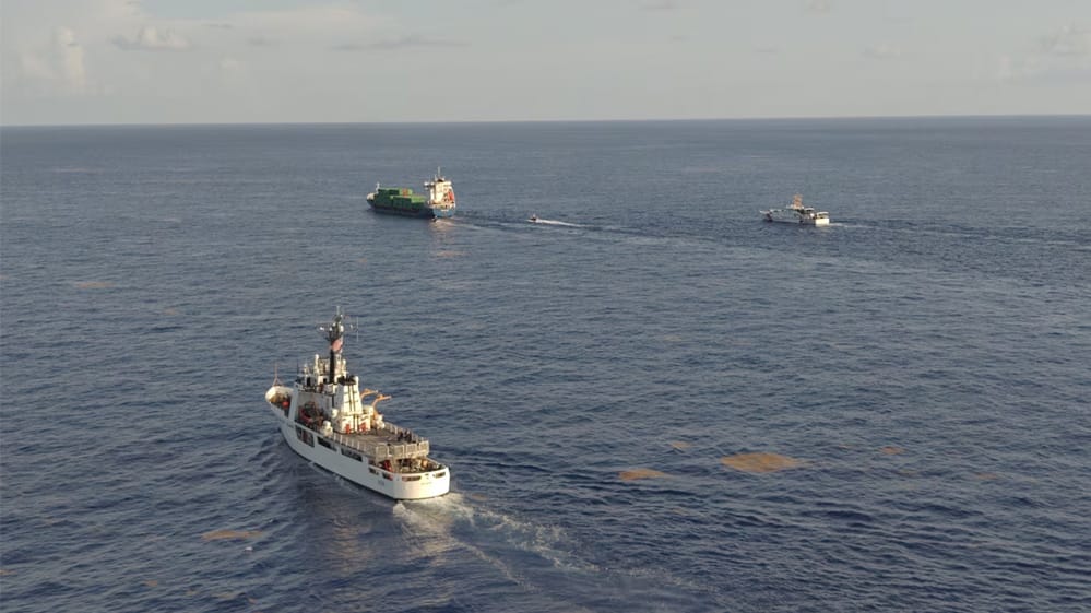 USCG cutters escorting containership