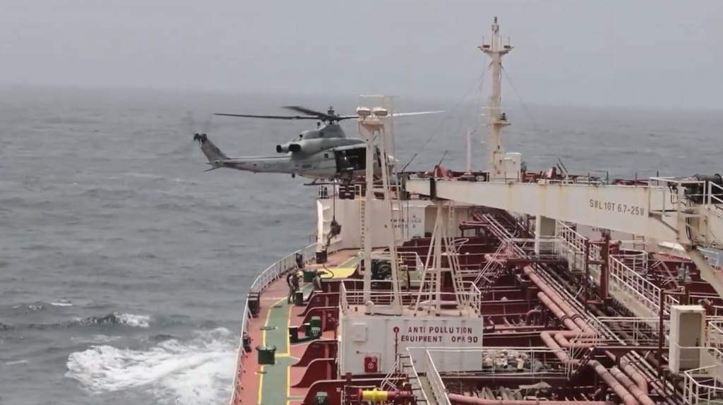U.S. Marines fast rope onto the deck of the product tanker Charminar (USMC / Central Command)