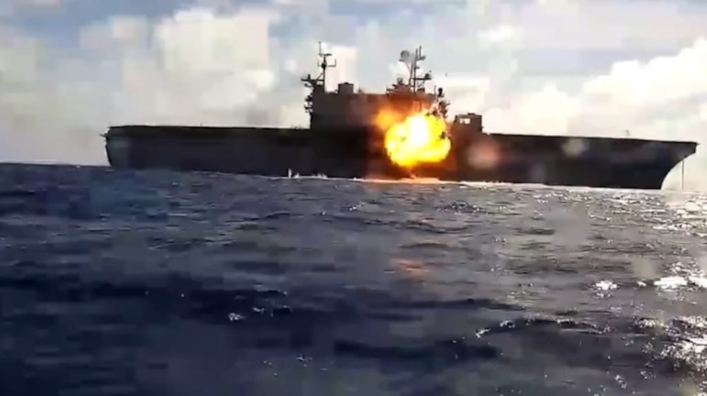 An unmanned bomb boat hits the former USS Peleleiu during a sinking exercise at RIMPAC 2026 (USN)