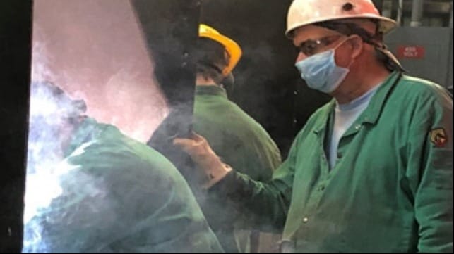 A Halter Marine mentor observes the welding work of a new apprentice.