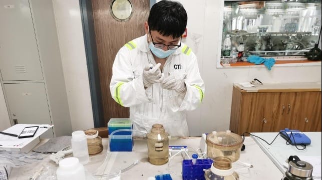 Maritec technicians taking ballast water samples (left), before carrying out indicative analysis