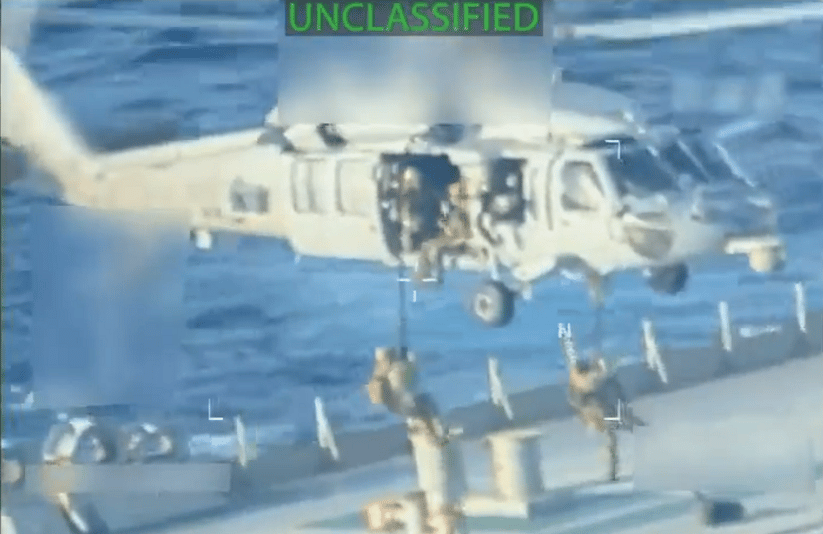 USCG personnel fast-rope onto the deck of the Skipper (U.S. Department of Justice)