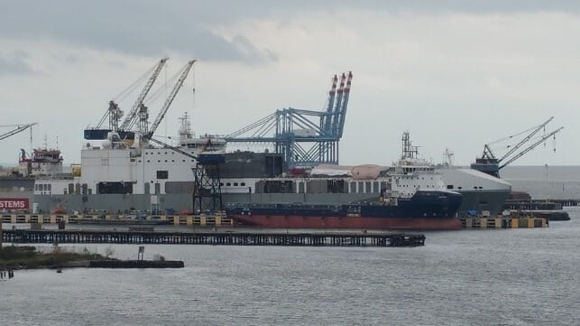 The ro/ro ferry Cragside undergoes conversion into special operations ship Ocean Trader, Mobile, Alabama, 2015 (background with tarps on deck) (Jabarnes / CC BY SA 4.0)