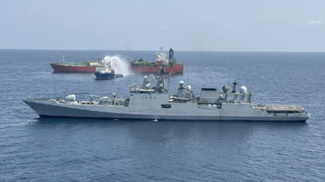 Indian warship and burning LPG carrier