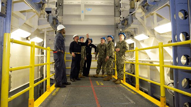 A team of experts inspects a weapons elevator aboard USS Gerald R. Ford (USN file image)