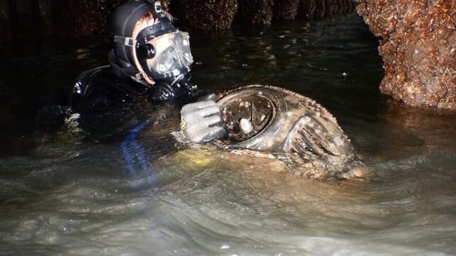 A police diver retrieves one of the two seabob mini-jetskis that the two men intended to use in their plot (AFP)