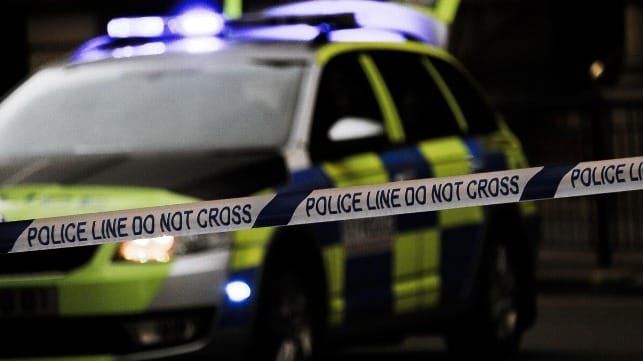 Police line tape with a police car