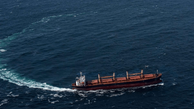 The bulker Matthew makes a hard turn to port as an Irish Air Force helicopter holds position over its bow (Irish Defence Forces)