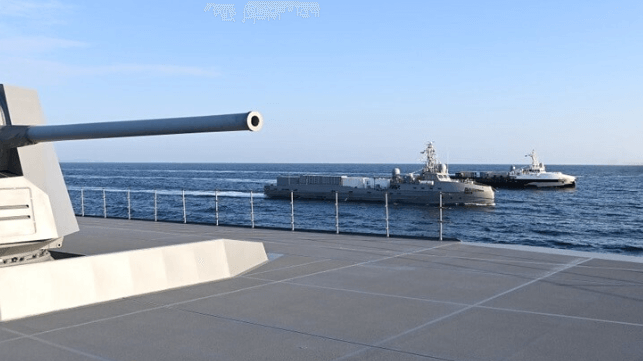 The U.S. Navy's "Ghost Fleet Overlord" crewboat-based USVs under way with a Japan Maritime Self Defense Warship (USN)