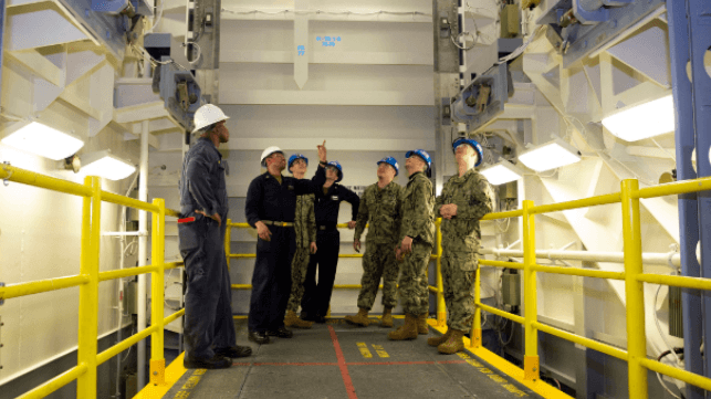 Sailors inside one of USS Ford's electromagnetically-actuated weapons elevators. The elevators require contractor servicing, Navy Secretary John Phelan says (USN file image)