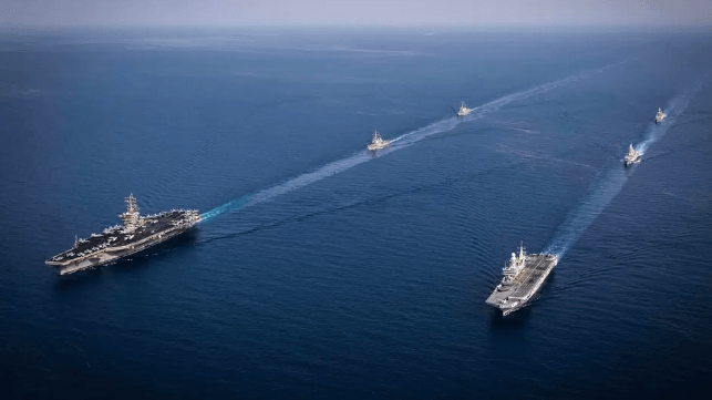 USS Dwight D. Eisenhower, left, steams alongside Italian Navy forces, June 7 (USN)