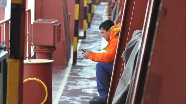 seafarer with cell phone