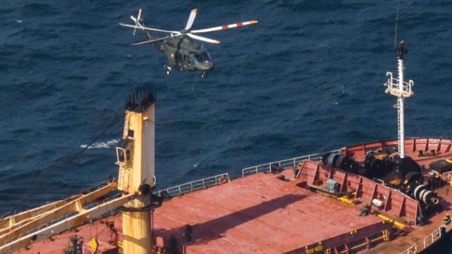 An Irish Air Force helicopter prepares to deliver a team of Irish Army commandos to the deck of the Matthew (Irish Defence Forces)