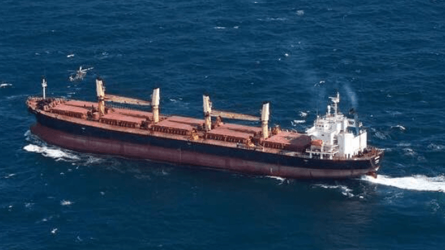 The bulker Matthew makes a hard turn to port as an Irish Air Force helicopter holds position over its bow (Irish Defence Forces)