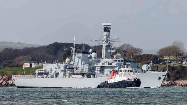 tug assisting warship
