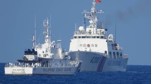 A Philippine Coast Guard vessel encounters a China Coast Guard cutter in close quarters (PCG)