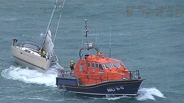 RNLI lifeboat rescuing a yacht in severe conditions