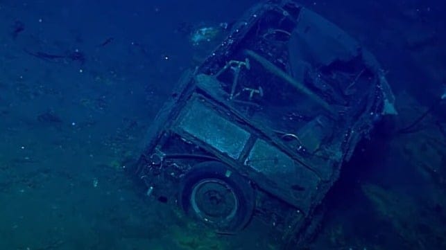 A small flash of chrome can be seen on the jeep's rear bumper, left of the spare tire (NOAA)