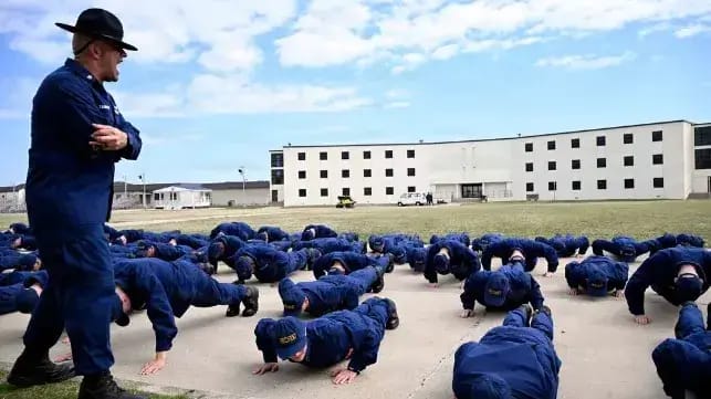 Recruits at Cape May, with aging barracks in the background (USCG)