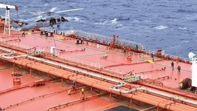 troops and helicopter boarding tanker