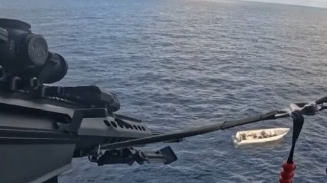 A Coast Guard sniper disables a drug boat's engines with a .50-caliber rifle (USCG)