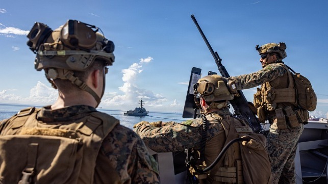 Marines aboard a U.S. Navy amphib stand watch as they transit the Gulf of Paria, just miles from Venezuelan shores (USN)