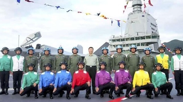 Xi Jinping, center, with crewmembers aboard Fujian (PLA / state media)