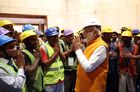 Prime Minister Modi in a hard hat mixes in amongst Indian construction workers (KARAM)