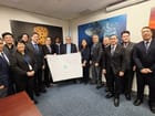 The Philippine delegation presenting the official copy of NAMRIA Chart No. 1567 entitled “Bajo de Masinloc and Approach” with DOALOS Deputy Director Alice Hicuburundi, centre left (DFA Philippines)