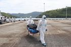 Servicemembers offload burned remains recovered from the June Aster (PCG)