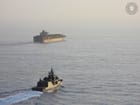 warship escorting containership in the Red Sea