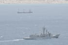 warship monitoring hijacked merchant ship