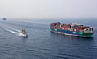 warship escorting containership in the Red Sea