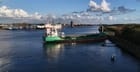 cargo ship aground on canal embankment