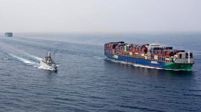 warship escorting containership in the Red Sea