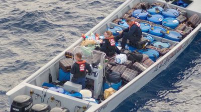 Tampa crewmembers take control of a powerful go-fast smuggling boat with cocaine aboard (USCG)