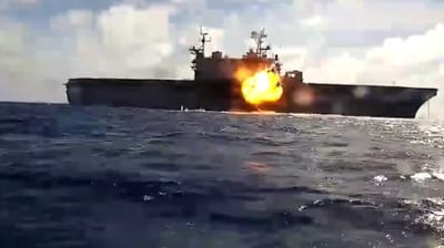 An unmanned bomb boat hits the former USS Peleleiu during a sinking exercise at RIMPAC 2026 (USN)