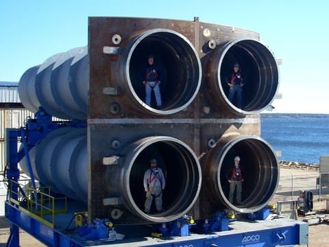 Workers pose with a quad pack of nuclear ballistic missile tubes for the Columbia-class (GDEB)