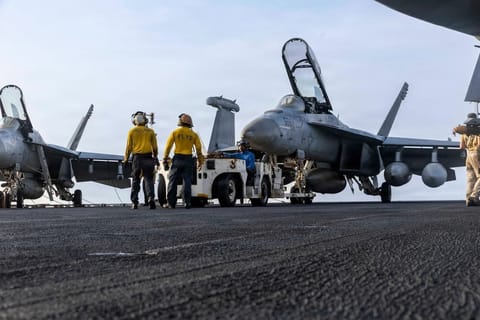 Sailors at work on the flight deck of USS Abraham Lincoln, July 30 (USN)