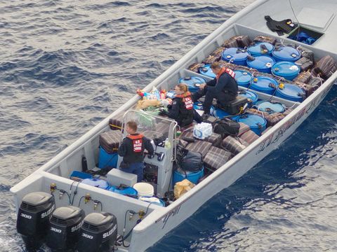 Tampa crewmembers take control of a powerful go-fast smuggling boat with cocaine aboard (USCG)