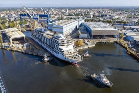 cruise ship leaving building dock